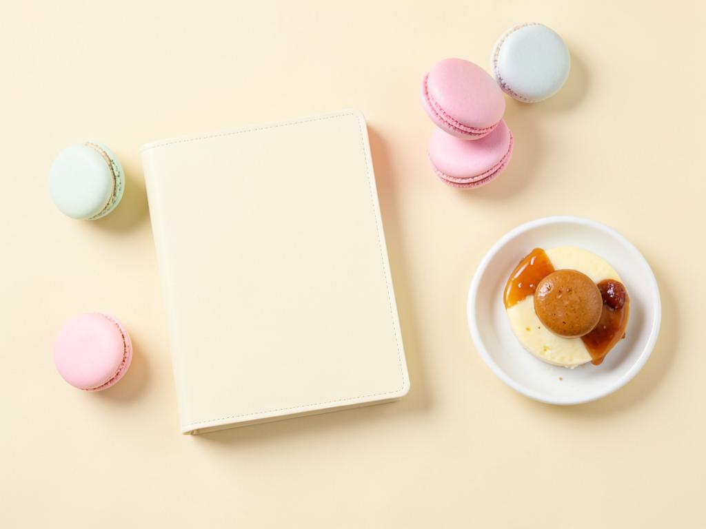 Cream passport booklet with pastel macarons and a small dessert